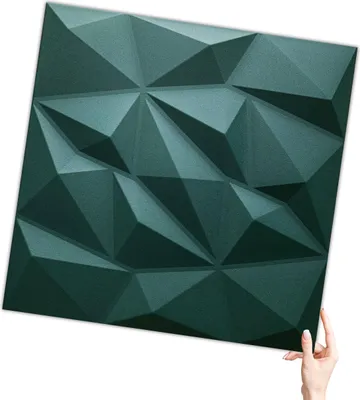 A hand holding a 3D wall panel.