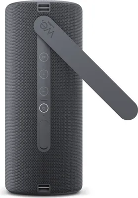 A close-up side view of a dark gray Bluetooth speaker with a gray handle extended.