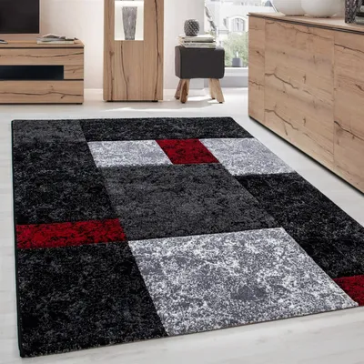 A modern living room with a geometric rug.