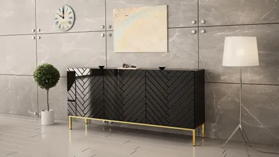 A modern black sideboard with gold legs is displayed against a grey tiled wall.