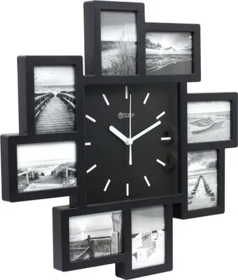 A black wall clock with multiple photo frames arranged around it.