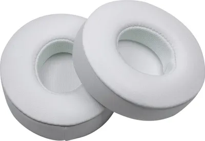 Two white ear pads for headphones.