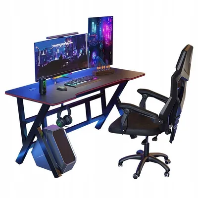 A gaming desk and chair setup with dual monitors, keyboard, mouse, and headphones.