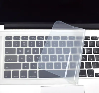 A clear, close-up shot of a laptop keyboard with a transparent keyboard cover partially obscuring the keys.