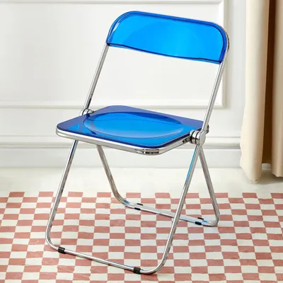 A blue transparent folding chair with a silver frame is shown in a room with a checkered floor and a white wall.