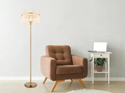 A floor lamp and armchair in a room.