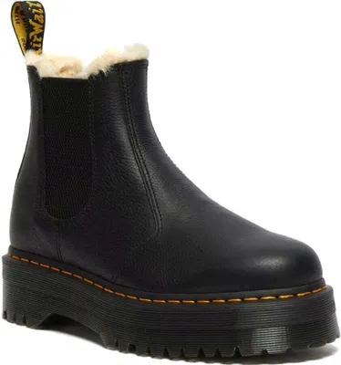 A black Dr. Martens boot with a platform sole and fur lining, shown against a white background.