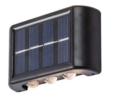 A black solar-powered wall light with four solar panels on top and three lights on the bottom, shown against a white background.