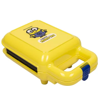 A yellow Minions-themed waffle maker is shown against a white background.