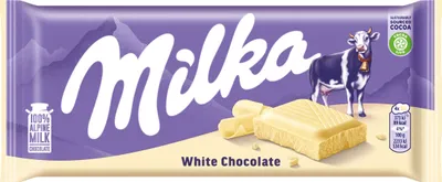 A Milka white chocolate bar with a cow and mountains on the packaging.