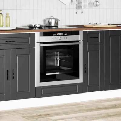 A modern kitchen scene with an built-in oven and cabinets.
