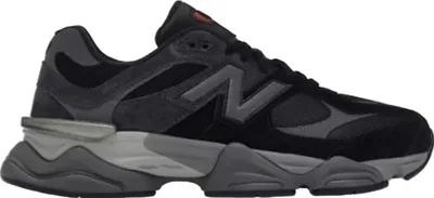 A side view of a black and gray New Balance sneaker against a white background.