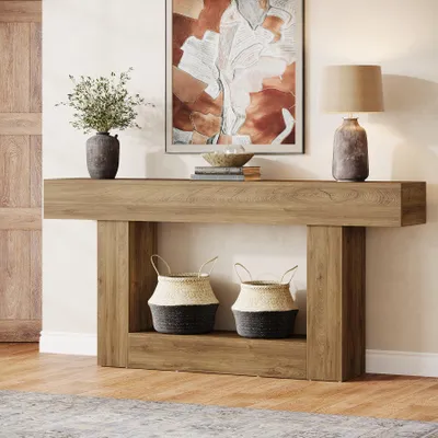 A console table with decorative items and storage baskets in a hallway or living room setting.