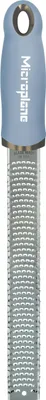A close-up studio shot of a Microplane grater.