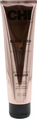 A rose gold colored tube of CHI Luxury Black Seed Oil Revitalizing Masque.