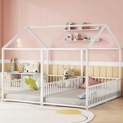 A child's bedroom with a white house-shaped bed frame, decorated with stuffed animals and pillows.