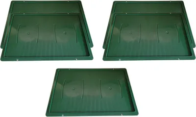 Three stacks of green plastic lids for vegetable crates, arranged in a top-down view.