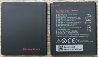 Two black Lenovo batteries are shown side-by-side on a wooden surface.