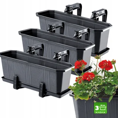 A set of three black balcony planters with integrated handles and saucers, with red geraniums planted in one of them.