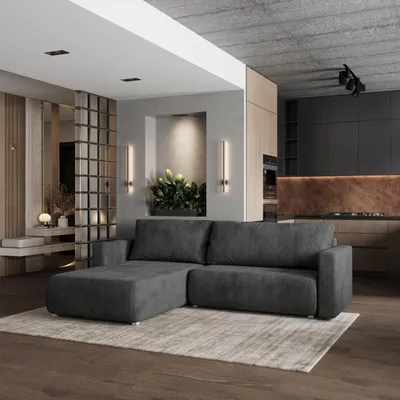 A modern living room and kitchen area with a sectional sofa in the foreground.