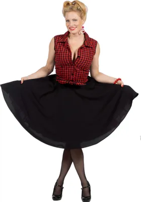 A woman is posing in a vintage-style outfit.