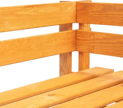 A close-up view of a wooden corner bench made of pallet wood.