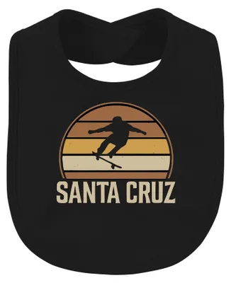 Imagen del producto de Babero para bebé con diseño retro de skate, con motivos de surf, atardecer y patinador, color negro
