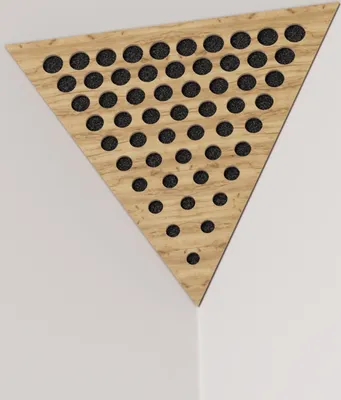A triangular acoustic panel with perforations is mounted on a white wall.