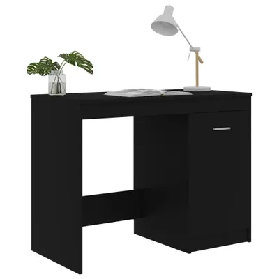 A black desk with a lamp and a plant on it, set against a white background.