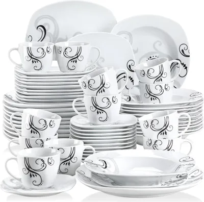 A collection of white ceramic dinnerware and cups with black and gray decorative swirls, neatly stacked and arranged.