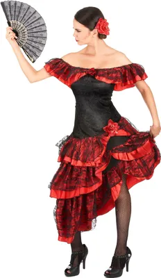 A woman in a flamenco dancer costume holding a fan.