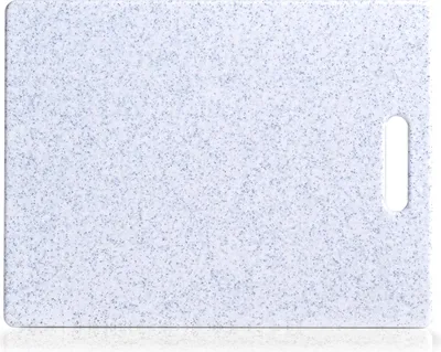 A top-down view of a speckled gray and white cutting board with a handle cutout on the right side.