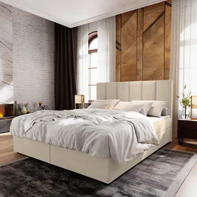 A bedroom scene featuring a large bed with a beige upholstered headboard and base, dressed in white bedding. The room has a modern, minimalist aesthetic with textured walls and wooden accents.
