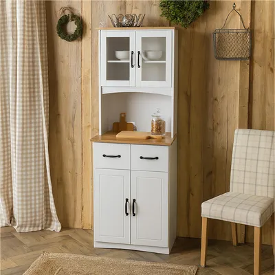 A white kitchen cabinet with glass doors and wooden top, set against a wooden wall.