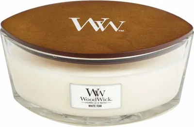A WoodWick White Teak scented candle in a clear glass jar with a wooden lid.