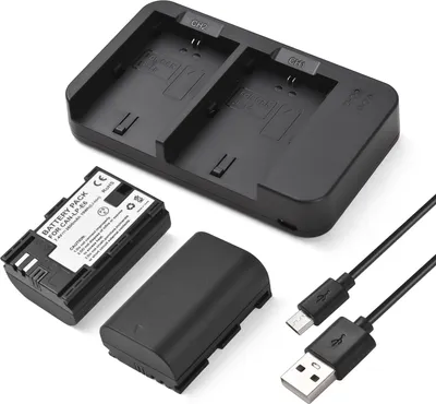 A product shot of a camera battery charger set, including the charger, two batteries, and USB cables, arranged on a white background.