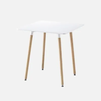 A square white table with wooden legs against a white background.