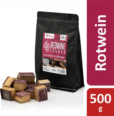 A bag of red wine smoking chunks and a pile of the chunks in front of it, on a white background.