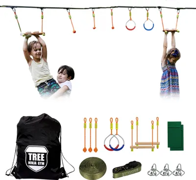 Children playing on a ninja obstacle course set up outdoors.