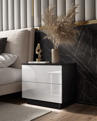 A modern bedroom setting with a nightstand next to a bed.
