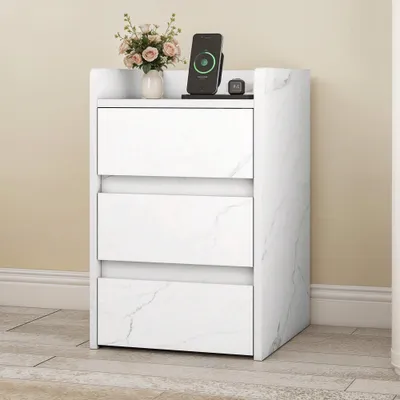 A white marble-patterned nightstand with three drawers is shown against a light beige wall.