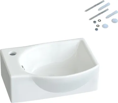 A white ceramic sink with mounting hardware.