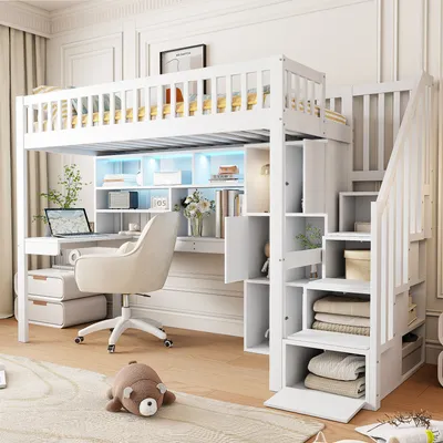A white loft bed with a desk, shelves, and stairs, set up in a room.