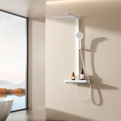 A modern bathroom with a large window overlooking a scenic landscape, featuring a white shower system with a glass shelf holding two bottles of soap.