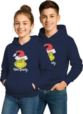 Two children wearing matching navy blue hoodies with a Grinch graphic on the front.