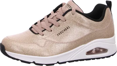 A side view of a single gold Skechers Uno sneaker.