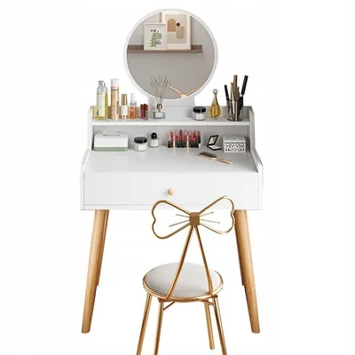A white vanity table with a round mirror and a gold chair in front of it, set against a white background.