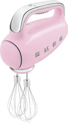 A pink Smeg hand mixer with silver accents and beaters is shown against a white background.