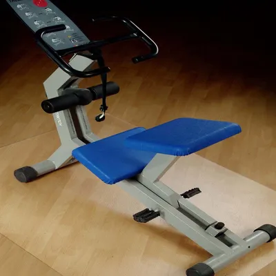 A fitness machine with blue padding on a wooden floor.