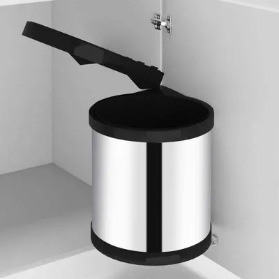 A stainless steel kitchen bin with a black lid is shown inside a white cabinet.